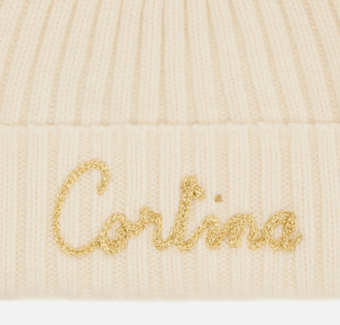 Berretto Wengen W F con pompon bianco